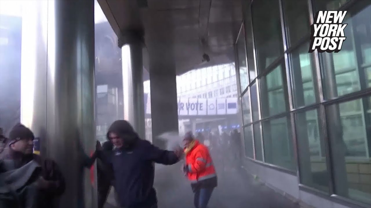 Farmers protesting outside European Parliament in Brussels are hosed by police